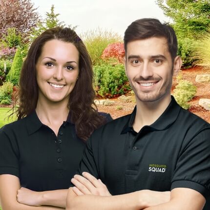 Mosquito Squad female and male owners wearing black polo shirts